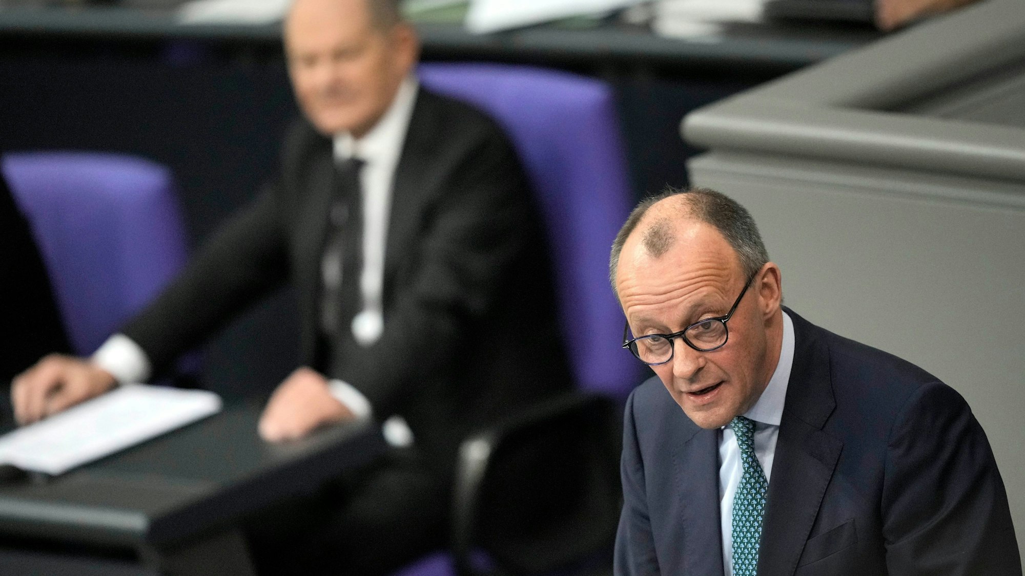 Opposition Christian Union parties floor leader Friedrich Merz, right, speaks, as German Chancellor Olaf Scholz, listens during a general debate on the budget at the German parliament Bundestag in Berlin, Germany, Wednesday, Jan. 31, 2024. (AP Photo/Ebrahim Noroozi)