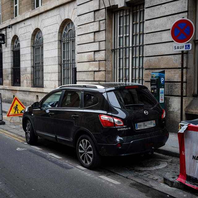 Cars are parked in Paris city center on February 2, 2024 as Paris' city hall is organizing a vote on February 4 on the creation of a special parking fee for heaviest and most polluting cars and SUVs. (Photo by Dimitar DILKOFF / AFP)