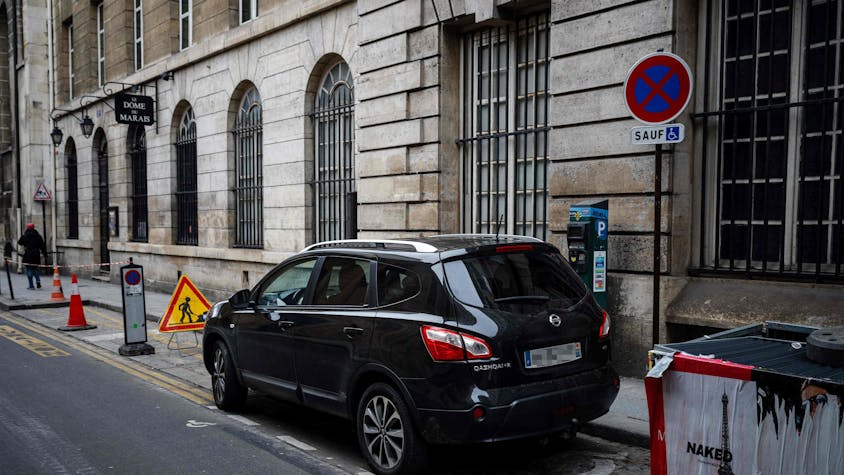 Cars are parked in Paris city center on February 2, 2024 as Paris' city hall is organizing a vote on February 4 on the creation of a special parking fee for heaviest and most polluting cars and SUVs. (Photo by Dimitar DILKOFF / AFP)