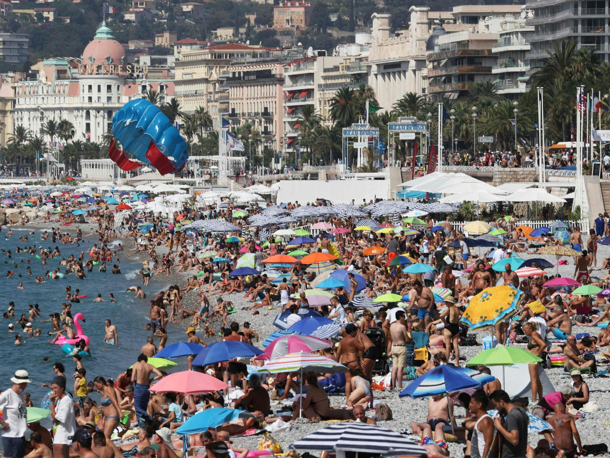 Badegäste kühlen am Strand entlang der «Promenade des Anglais» ab.