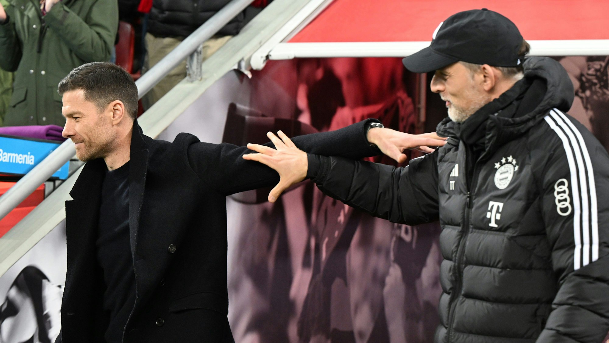 Leverkusens Trainer Xabi Alonso und Münchens Trainer Thomas Tuchel (r) vor dem Spiel.