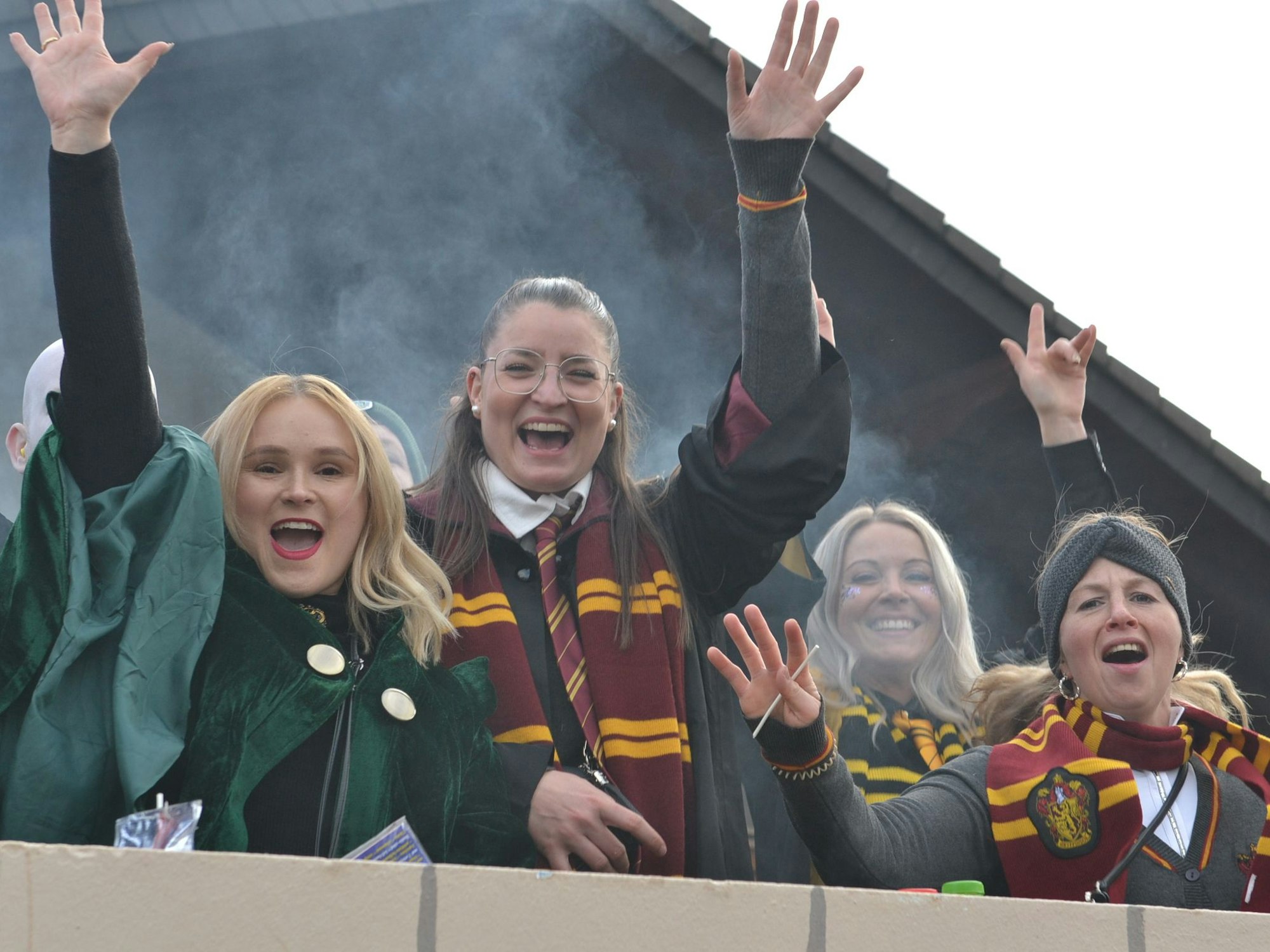 Als Harry Potter verkleidete Karnevalistinnen grüßen von einem Wagen in Groß-Vernich.