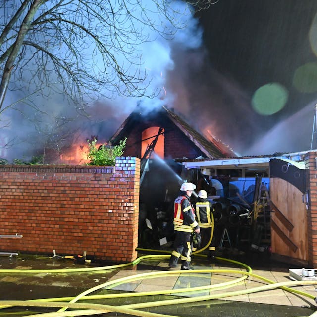 Feuerwehrleute löschen in Kerpen einen brennenden Hausanbau.