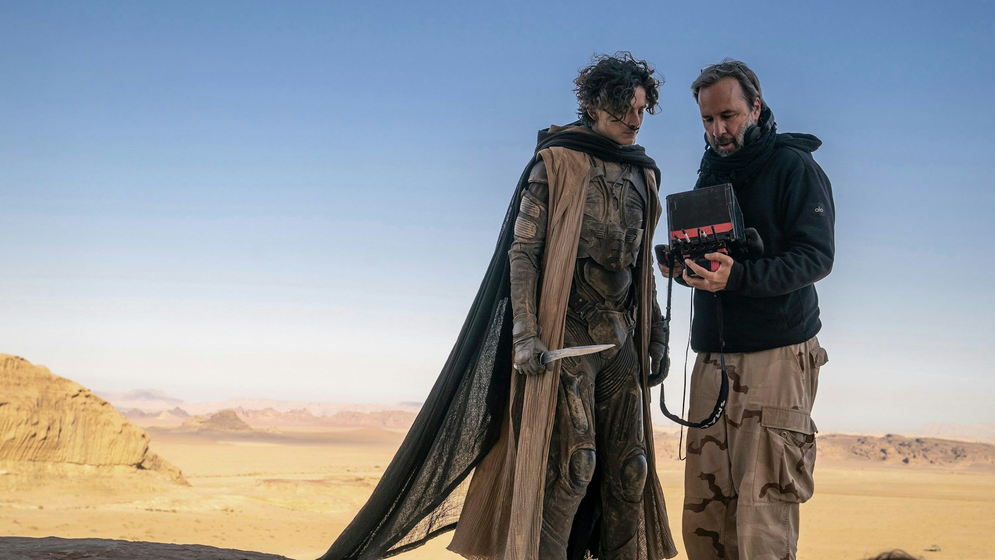 This image released by Warner Bros. Pictures shows director Denis Villeneuve, right, with actor Timothee Chalamet on the set of "Dune: Part Two." (Niko Tavernise/Warner Bros. Pictures via AP)
