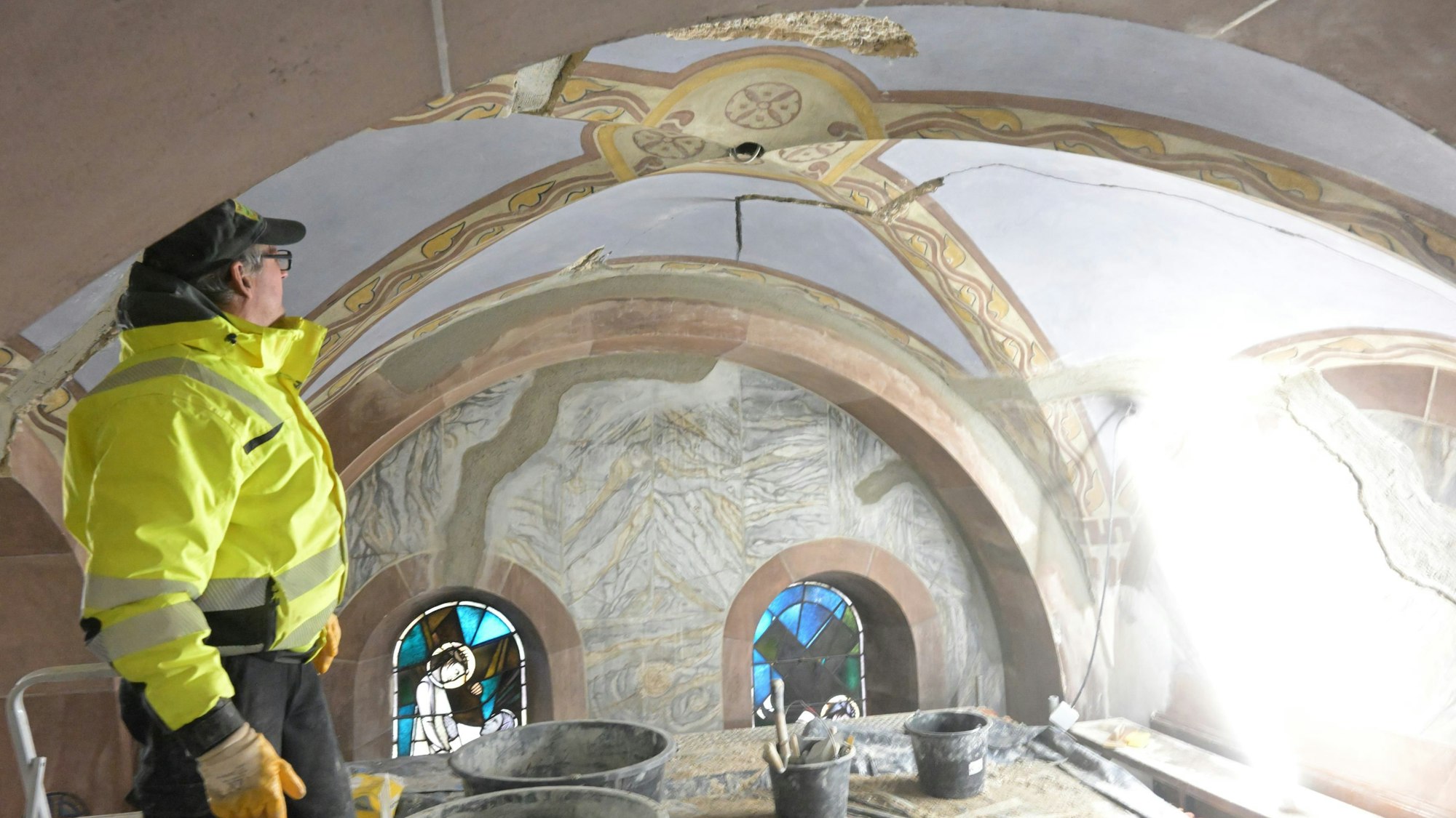 Ein Arbeiter steht in einem Gewölbe der Seitenschiffe von St. Laurentius, das bereits restauriert ist.
