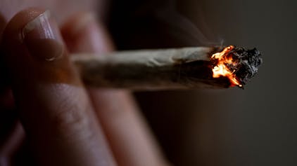 Eine Person raucht einen Joint.