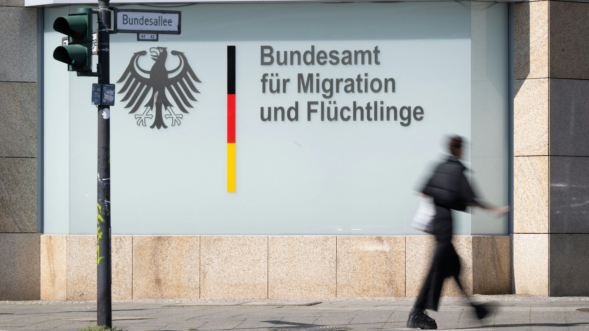 ARCHIV - 24.08.2023, Berlin: Ein Mann geht vor dem Bundesamt für Migration und Flüchtlinge vorbei.
