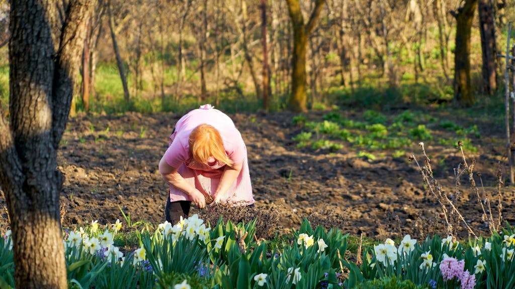 Eine Frau arbeitet im März im Garten