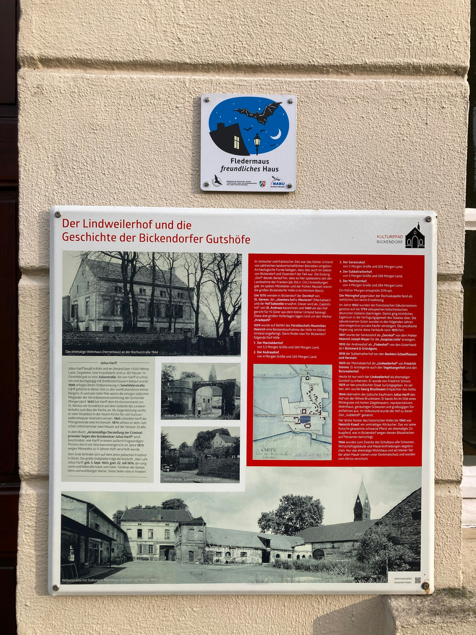 Eine Plakette an der Hauswand des Gutshauses informiert über die Geschichte des Hofs.