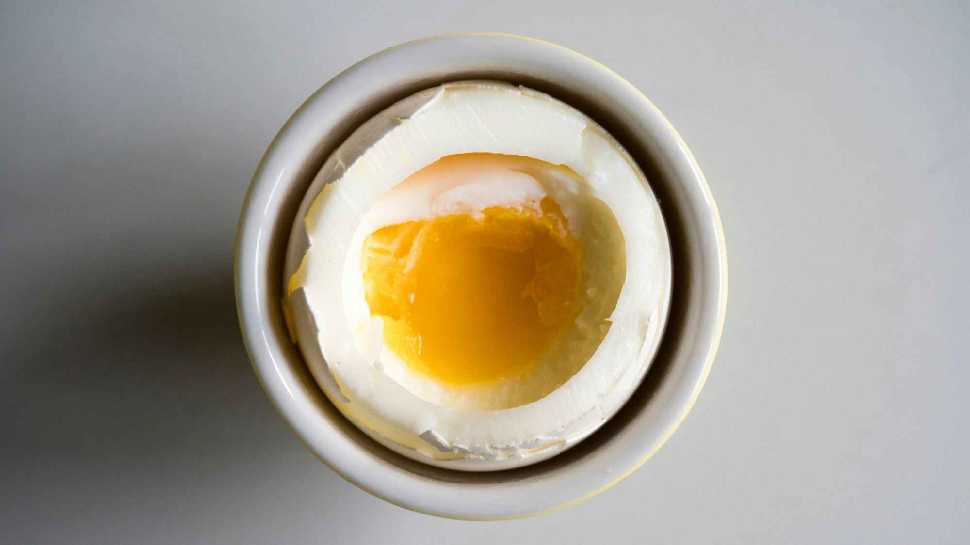 Soft boiled breakfast egg on a white porcelain plate
EThamPhoto/ Getty Images