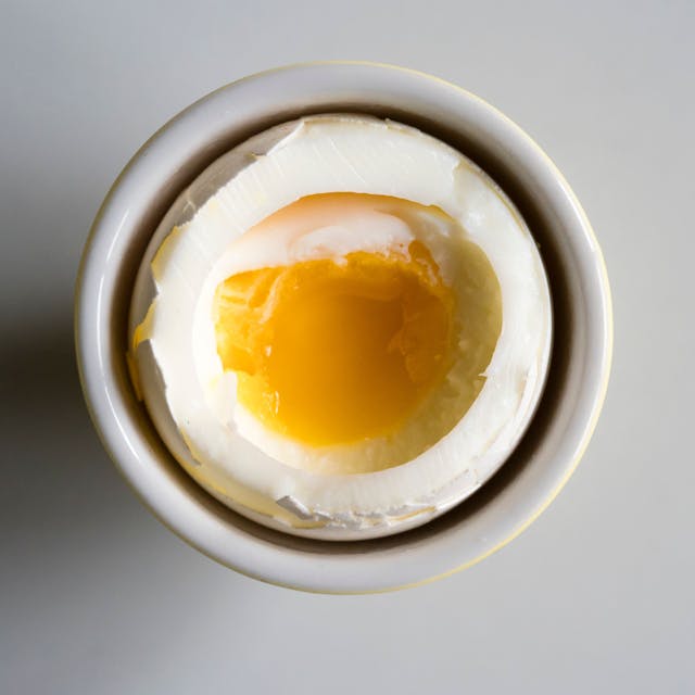 Soft boiled breakfast egg on a white porcelain plate
EThamPhoto/ Getty Images
