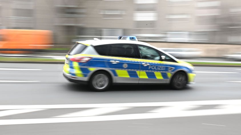 Zu sehen ist ein Polizeiwagen der durch die Kölner Innenstadt rast.