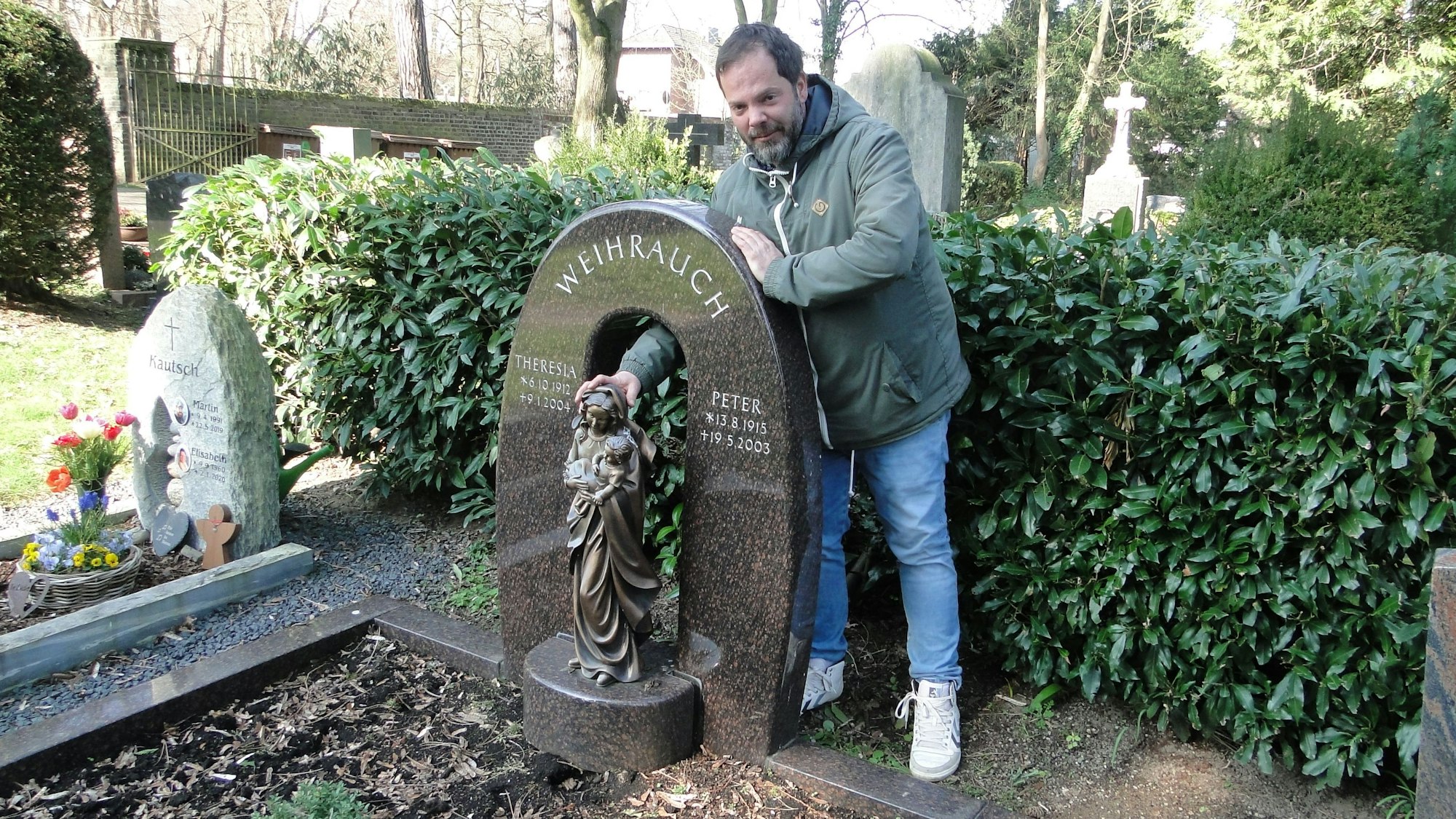 René Weihrauch demonstriert den Schaden an einer Marienstatue, deren Sockel  aus dem Grabstein gebrochen wurde. Mit den Weihrauchs, die dort liegen, ist er nicht verwandt.