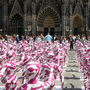 Eine Installation mit Kinderfiguren, die mit Flatterband umwickelt sind, vor dem Kölner Dom erinnert an den Missbrauchsskandal in der katholischen Kirche. (Archivbild)