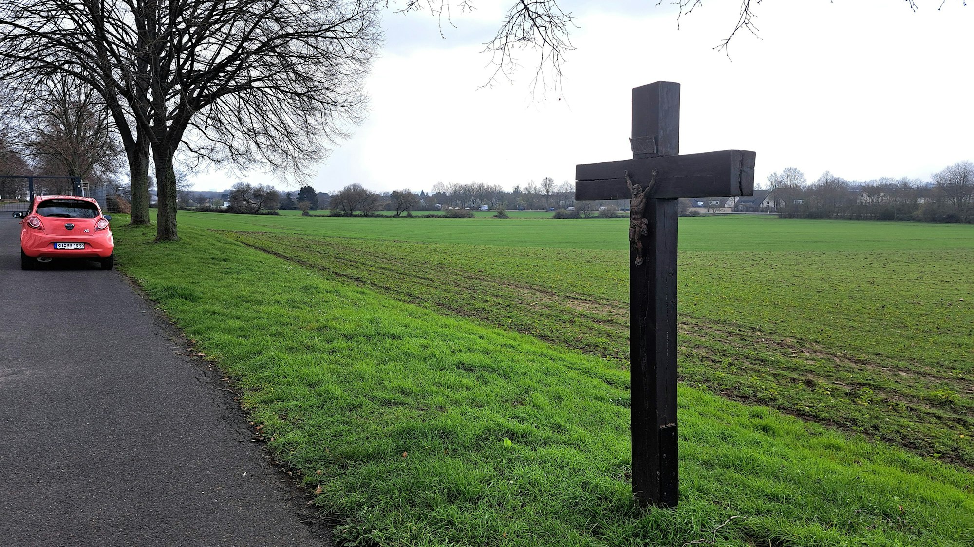 Am Rande des bislang landwirtschaftlich genutzten Areals unterhalb des Südfriedhofs, auf dem ein Wohnheim für Geflüchtete entstehen könnte, steht ein großes Kruzifix.