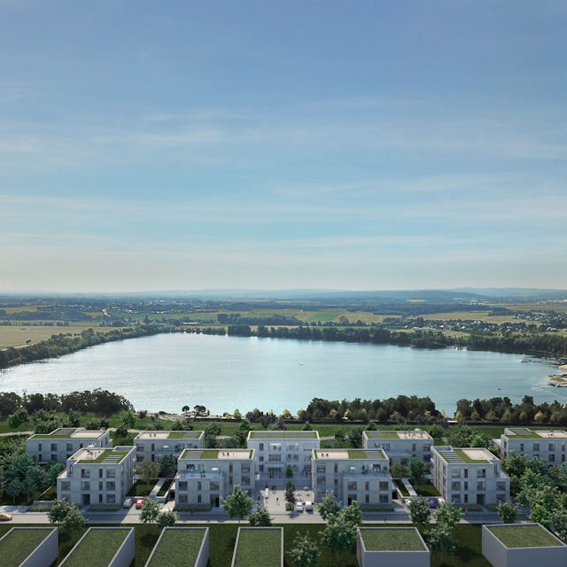 Eine Visualisierung zeigt mehrere helle Gebäude mit Gründächern vor der Kulisse des Zülpicher Wassersportsees.