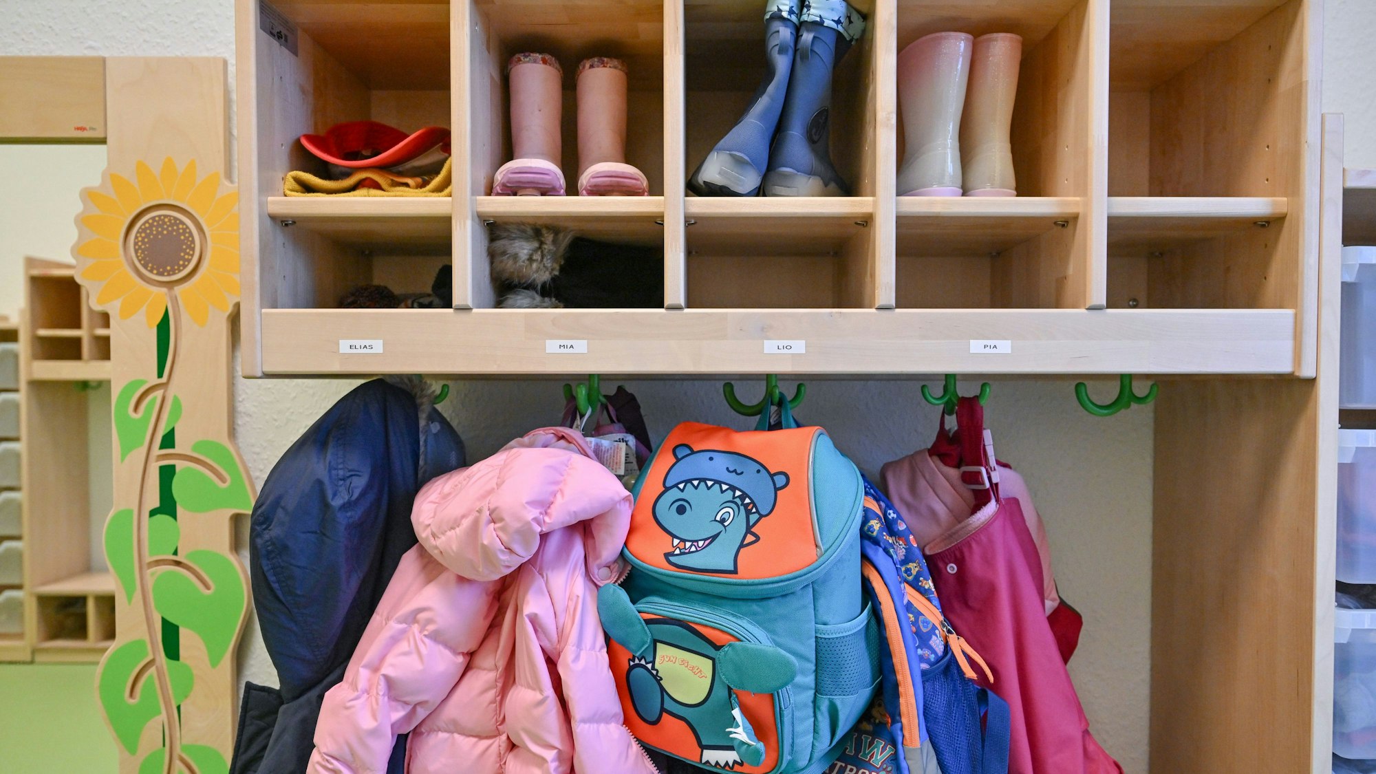 Kleidung von Kindern hängt in einer Kita.