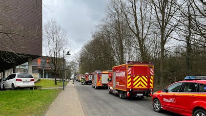 Feuerwehrfahrzeuge stehen an der Straße zur LVR-Schule am Königsforst in Rösrath.