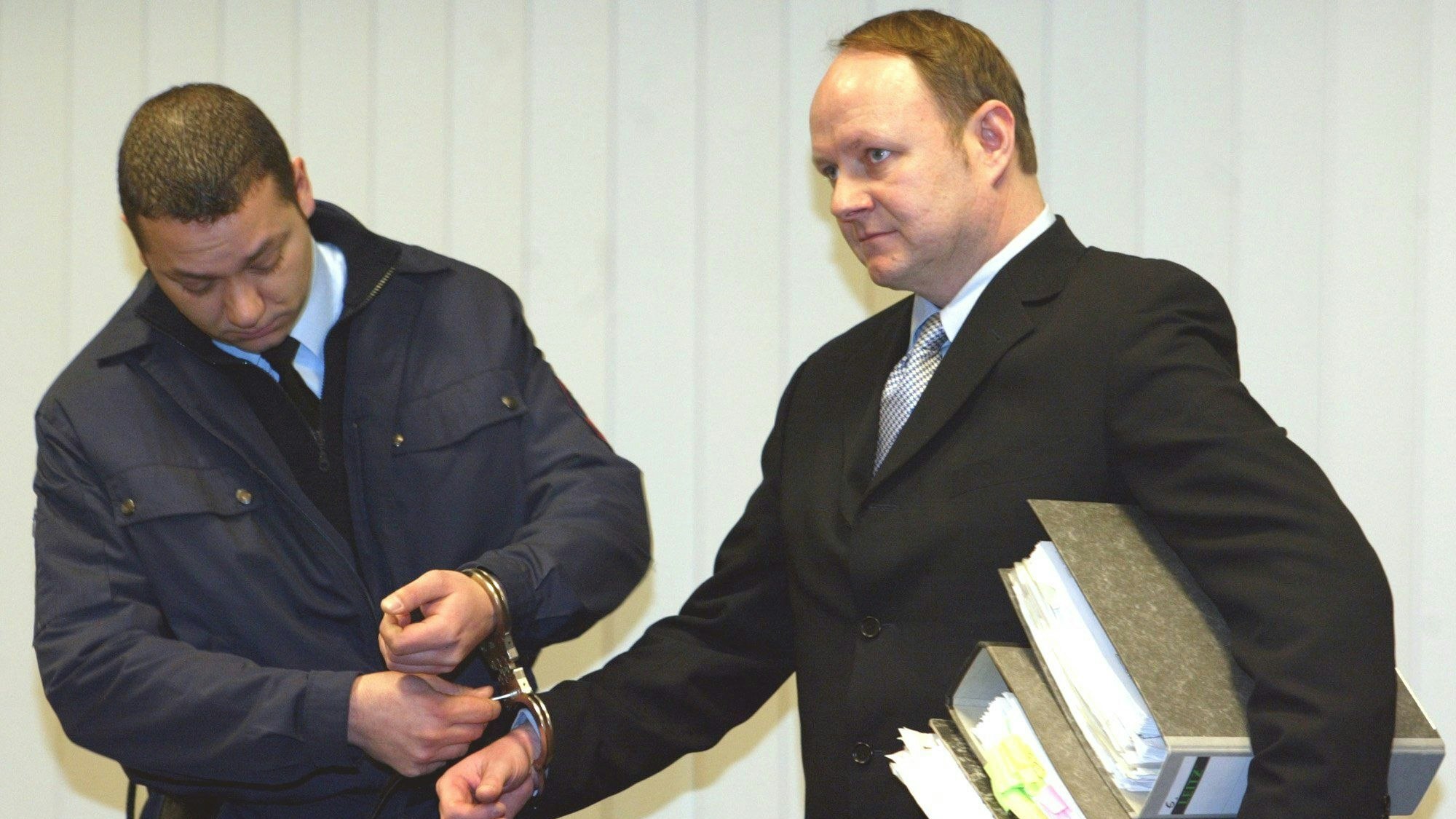 Jürgen Harksen (r.) lässt sich bei seinem Prozess 2003 die Handschellen abnehmen.