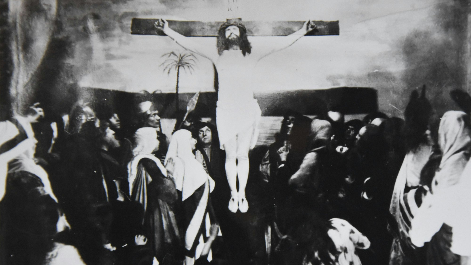Eine alte Schwarz-Weiß-Fotografie zeigt die Kreuzigung Jesu in einem Passionsspiel.