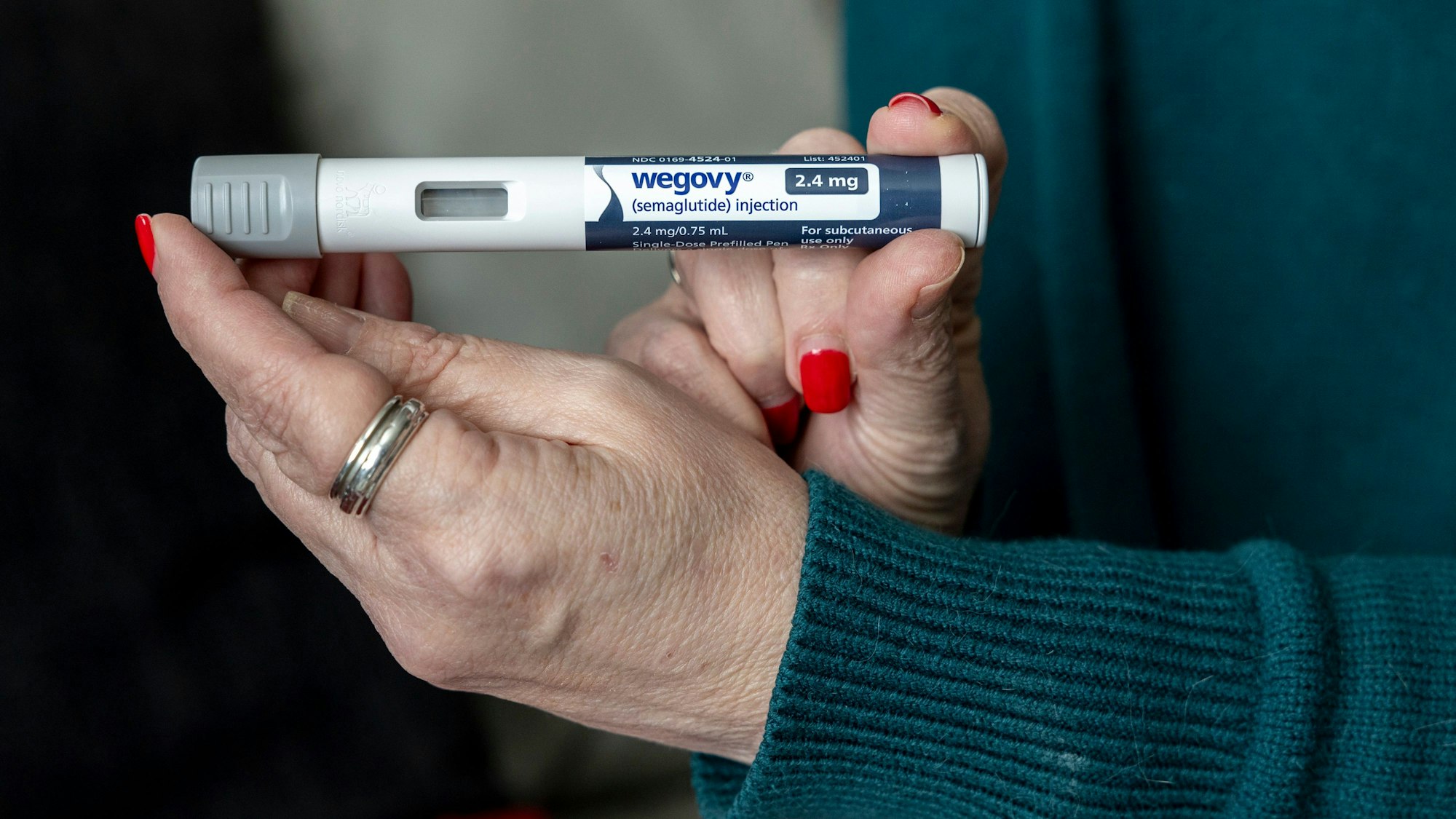 FILE - Donna Cooper holds up a dosage of Wegovy, a drug used for weight loss, at her home, March 1, 2024, in Front Royal, Va. The popular weight-loss drug Wegovy may be paid for by Medicare — as long as patients using it also have heart disease and need to reduce the risk of future heart attacks, strokes and other serious problems, federal officials said Thursday, March 21. (AP Photo/Amanda Andrade-Rhoades, File)