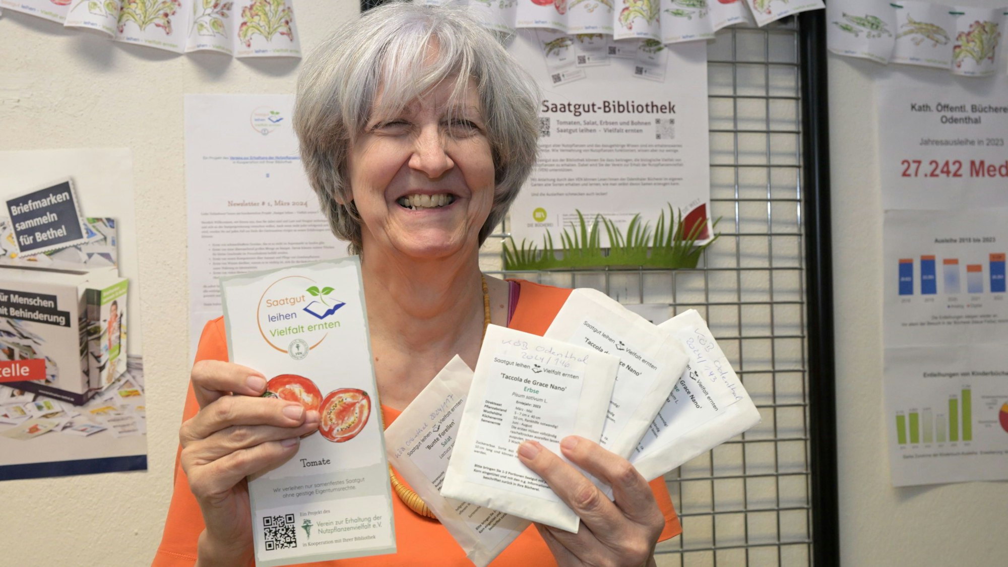 Bücherei-Leiterin Barbara Dinges hält Tütchen mit Pflanzensamen in den Händen.