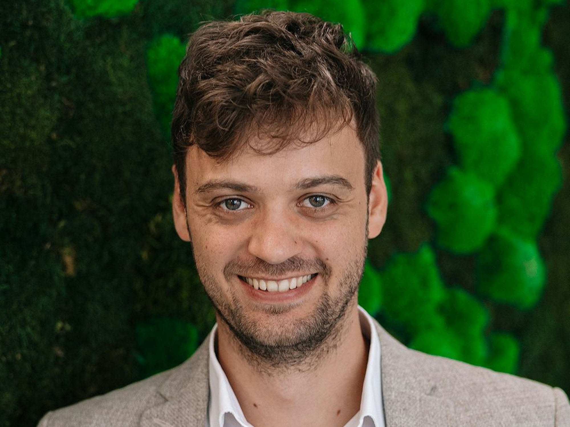 Florian Antwerpen, Co-Gründer und Geschäftsführer der Kyon Energy Solutions, steht vor einem grünen Hintergrund.