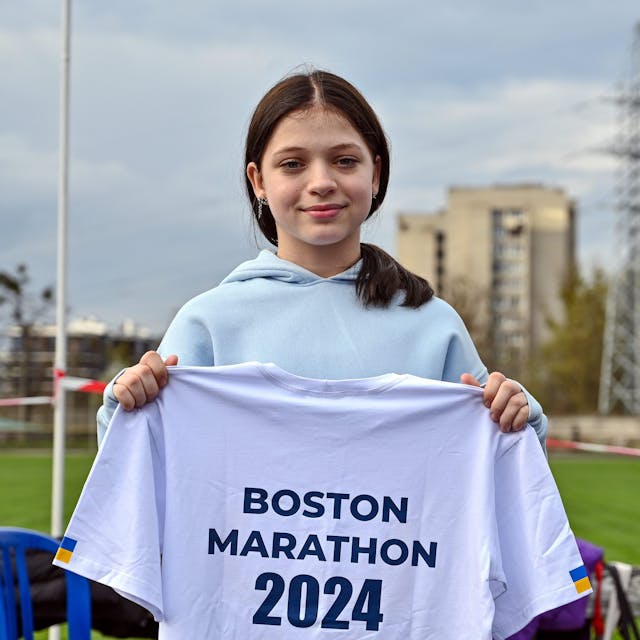 Ukraine, Lwiw: Die 12-jährige Ukrainerin Jana Stepanenko zeigt ein T-Shirt mit der Aufschrift „Boston Marathon 2024“.