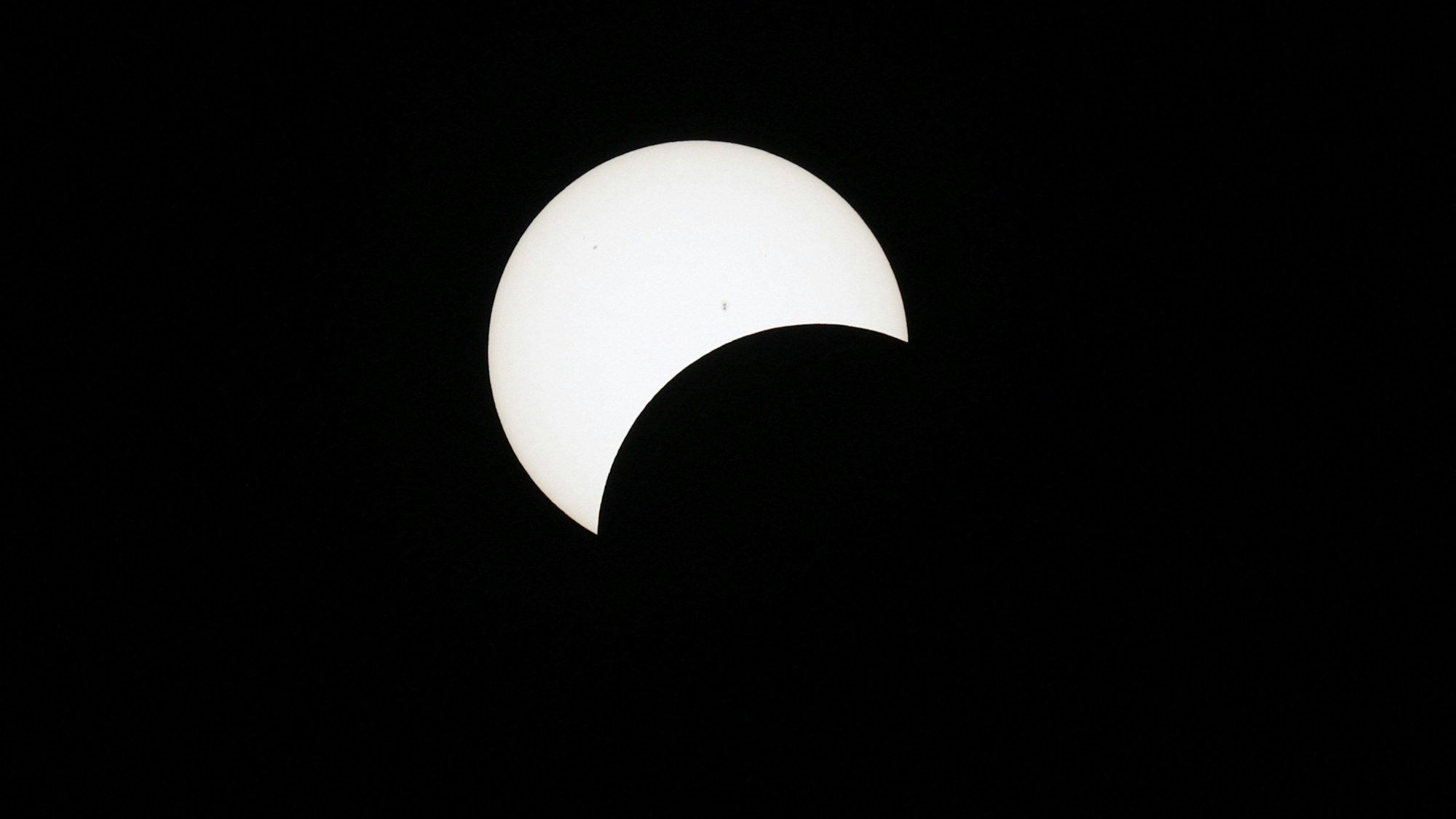 HOULTON, MAINE - APRIL 08: The moon crosses the sun during the eclipse on April 08, 2024 in Houlton, Maine. Millions of people have flocked to areas across North America that are in the "path of totality" in order to experience a total solar eclipse. During the event, the moon will pass in between the sun and the Earth, appearing to block the sun.   Joe Raedle/Getty Images/AFP (Photo by JOE RAEDLE / GETTY IMAGES NORTH AMERICA / Getty Images via AFP)