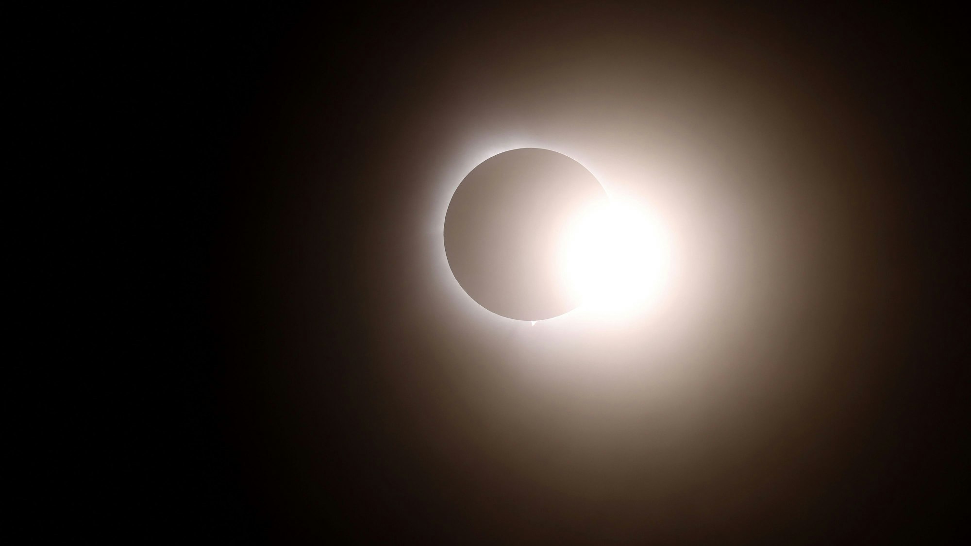 MARTIN, OHIO - APRIL 08: The moon passes in front of the sun during a solar eclipse on April 08, 2024 in Martin Ohio. Millions of people have flocked to areas across North America that are in the "path of totality" in order to experience a total solar eclipse. During the event, the moon will pass in between the sun and the Earth, appearing to block the sun.   Gregory Shamus/Getty Images/AFP (Photo by Gregory Shamus / GETTY IMAGES NORTH AMERICA / Getty Images via AFP)