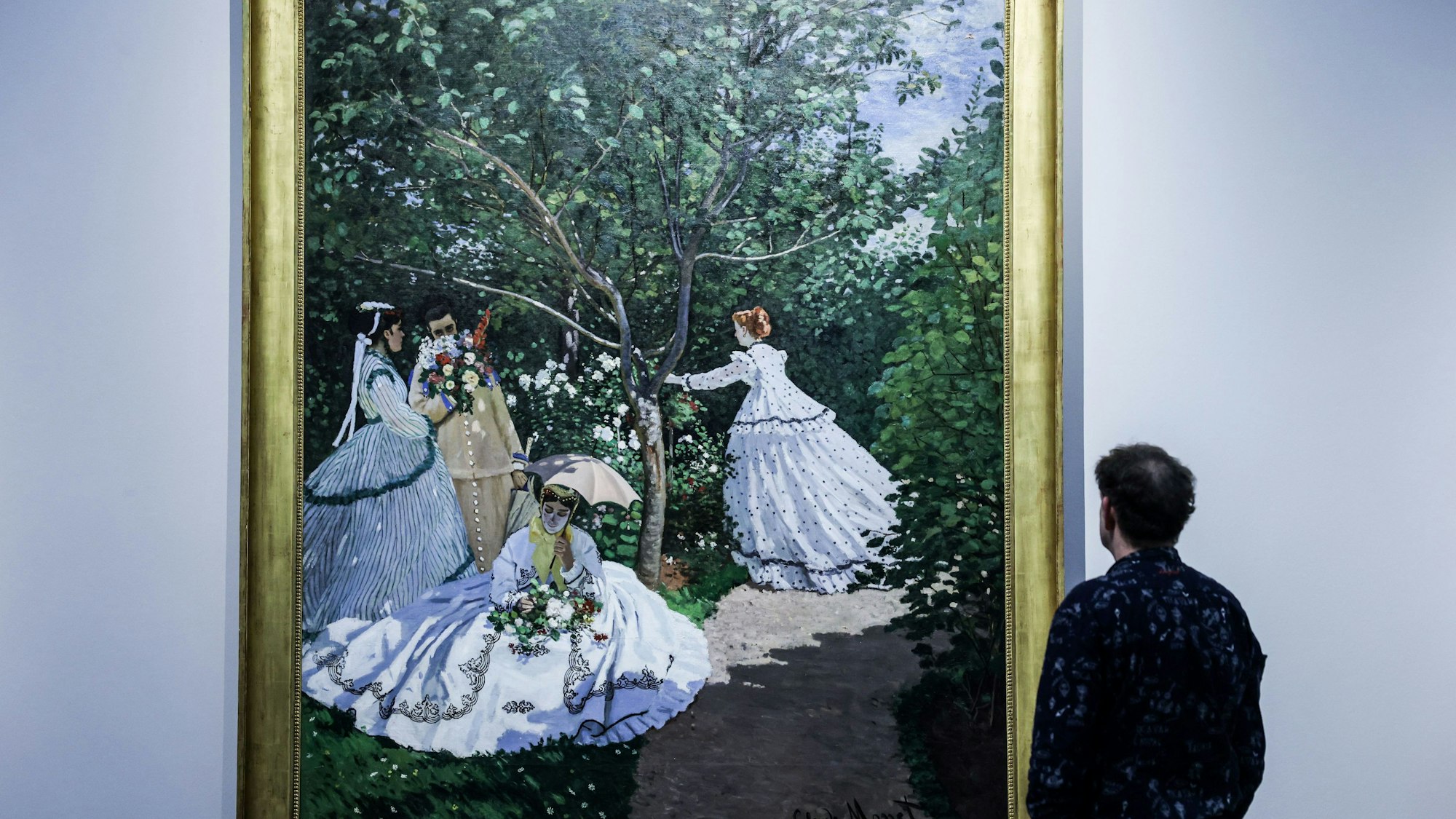 Ein Mann betrachtet das Gemälde ·Frauen im Garten von Claude Monet im Rahmen der Ausstellung „1863 - Paris - 1874: Revolution in der Kunst“ im Wallraf-Richartz Museum