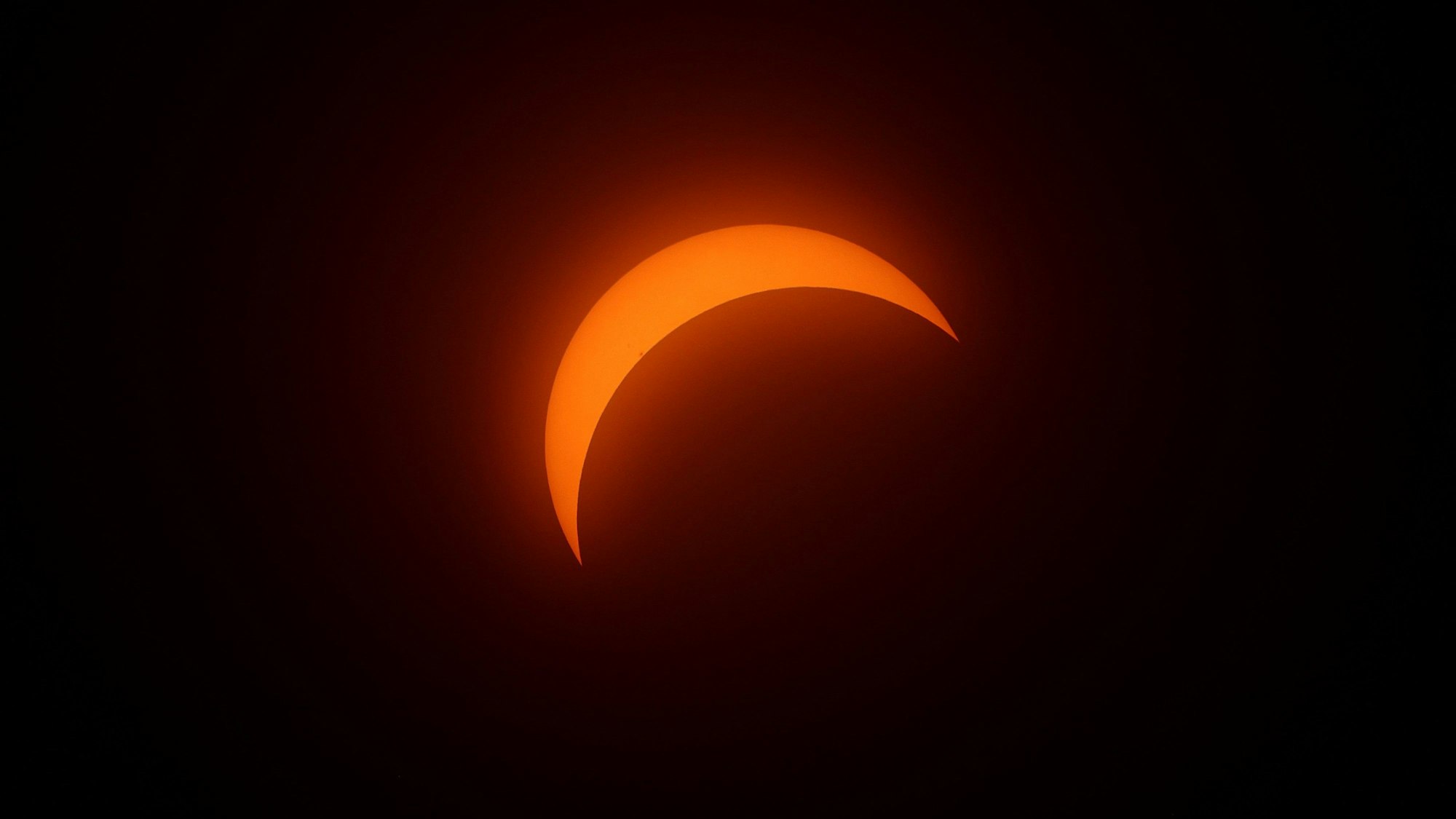 MARTIN, OHIO - APRIL 08: A crescent sun is seen during a solar eclipse on April 08, 2024 in Martin Ohio. Millions of people have flocked to areas across North America that are in the "path of totality" in order to experience a total solar eclipse. During the event, the moon will pass in between the sun and the Earth, appearing to block the sun.   Gregory Shamus/Getty Images/AFP (Photo by Gregory Shamus / GETTY IMAGES NORTH AMERICA / Getty Images via AFP)