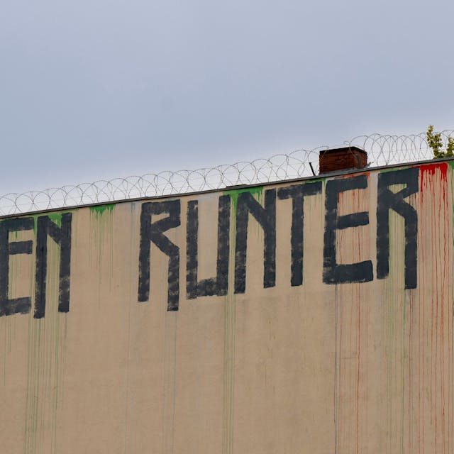 Berlin: Der Schriftzug „Mieten runter“ ist an der Wand eines Miethauses mit Graffiti beschmiert.