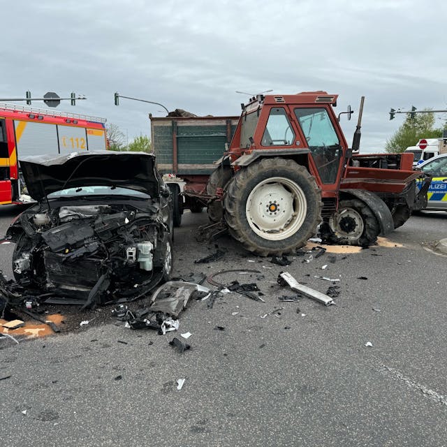 Das Bild zeigt einen beschädigten Pkw und einen beschädigten Traktor