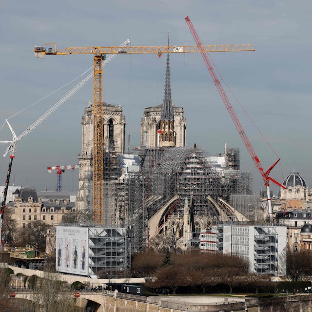 (FILES) This photograph taken on March 14, 2024, shows a view of the Notre-Dame de Paris Cathedral and its new wooden spire partially covered in lead under reconstruction with cranes and scaffholdings in Paris. A huge fire swept through the roof of the famed Notre-Dame Cathedral in central Paris on April 15, 2019, and five years later, the reconstruction advances in its final stages before the reopening planned for the end of the year. (Photo by Ludovic MARIN / AFP)
