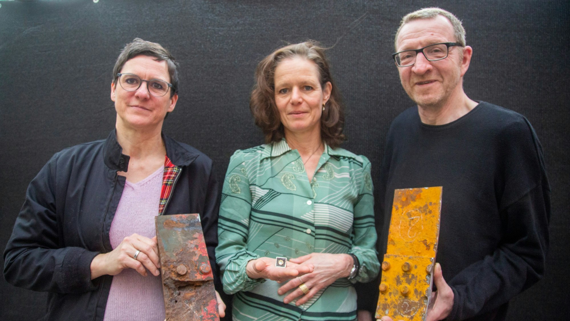 Die Künstler Ines Lang, Bettina Schön, Rupert Franzen mit rostigen Blechteilen des historischen Ratsschiffes MS Stadt Köln