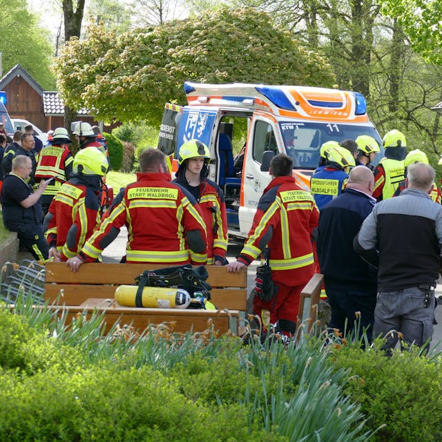 Rettungskräfte stehen vor dem betroffenen Gebäude in der Waldbröler Ortschaft Pulvermühle. Dort war ein Mensch ums Leben gekommen.