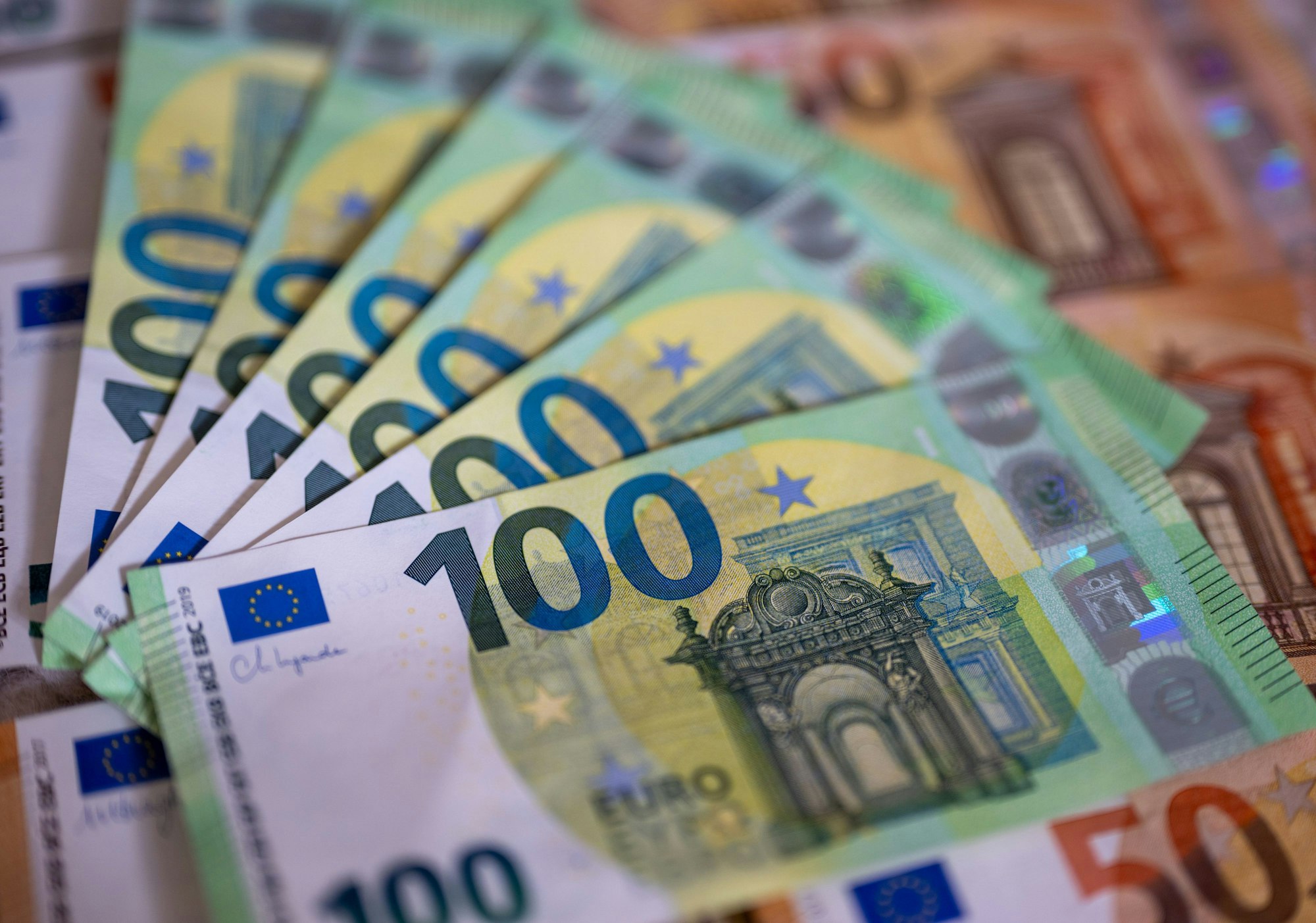 Geldscheine mit dem Wert von 100 und 50 Euro liegen auf einem Tisch.