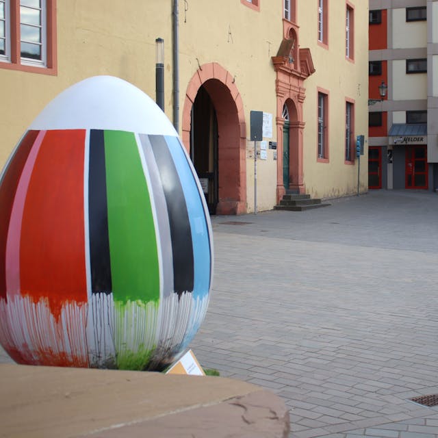 Die freie Fläche vor dem St.-Michael Gymnasium. Dort waren früher Parkplätze. Im Vordergrund steht ein überdimensionales Kunstwerk, das ein Ei darstellt.