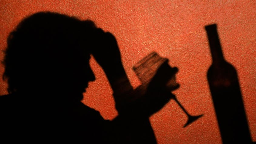 Der Schatten einer Frau, die ein Glas Wein trinkt, ist an der Wand in einer Kneipe in Frankfurt (Oder) zu erkennen.  Laut einer aktuellen Studie sterben Alkoholabhängige deutlich früher.&nbsp;