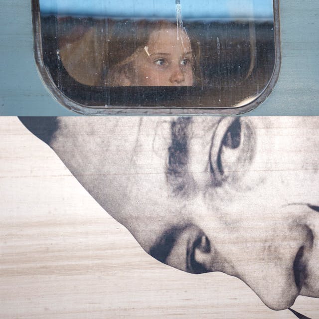 A child looks out from the window of a train displaying an advert to a Salvador Dali exhibition, at Gara de Nord, the main railway station in Bucharest, Romania,&nbsp;