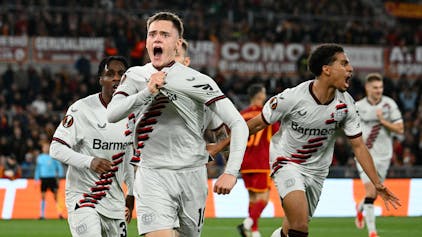 Bayer Leverkusen's German midfielder #10 Florian Wirtz celebrates with teammates after scoring his team first goal during the UEFA Europa League semi final first leg football match between AS Roma and Bayern Leverkusen at the Olympic stadium on May 2, 2024 in Rome. (Photo by Alberto PIZZOLI / AFP)