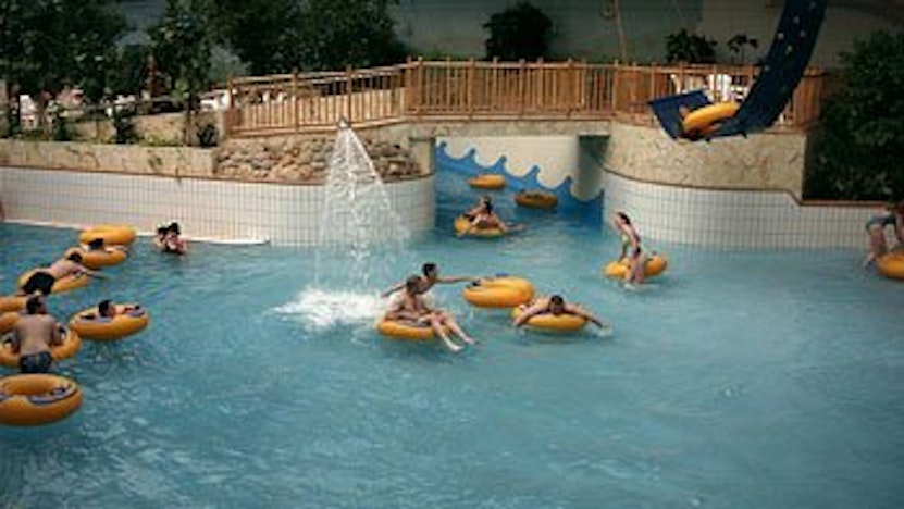 Kinder auf gelben Ringen in einem Schwimmbecken