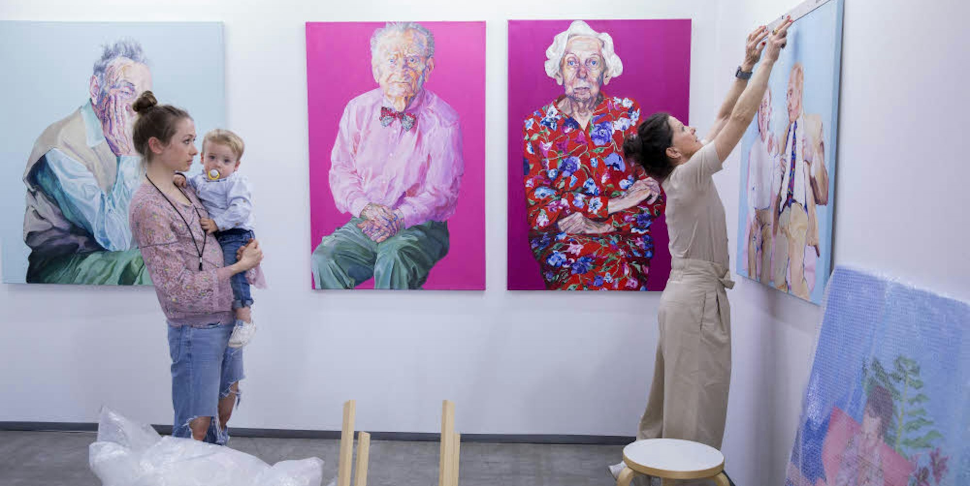 Janina Christine Brügel mit Sohn beim Hängen ihrer Portraits aus der Serie „Age“