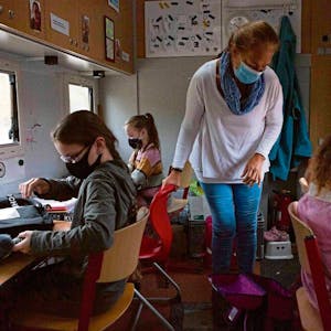 Lehrerin Katja Düsener unterrichtet Samantha (r.), Loreen (l. vorne) und Joana in ihrem Schulbus.