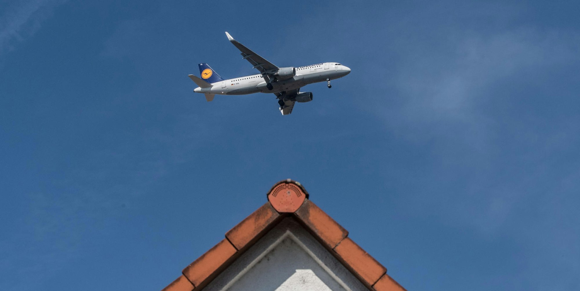 Flugzeug über einem Wohnhaus (Symbolbild)