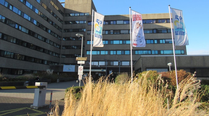 Das Gebäude des Krankenhauses mit Flaggen davor.