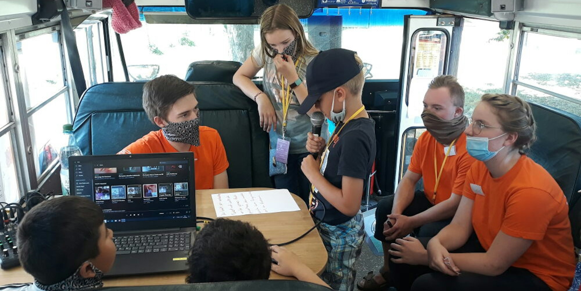 In dem gelben Jugendkulturbus produziert das Medienteam eine tägliche Radiosendung. Einen Musikwunsch erfüllt die Radioredaktion für sechs „Siegis“.