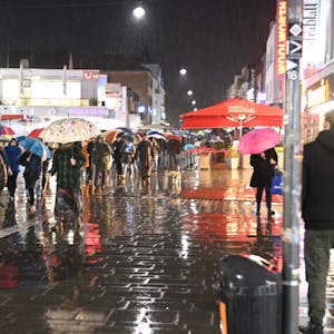 Mit Regenschirmen zogen die „Corona-Spaziergänger“ durch die Stadtmitte. Eine Gegendemo stand am Trotzenburgplatz.
