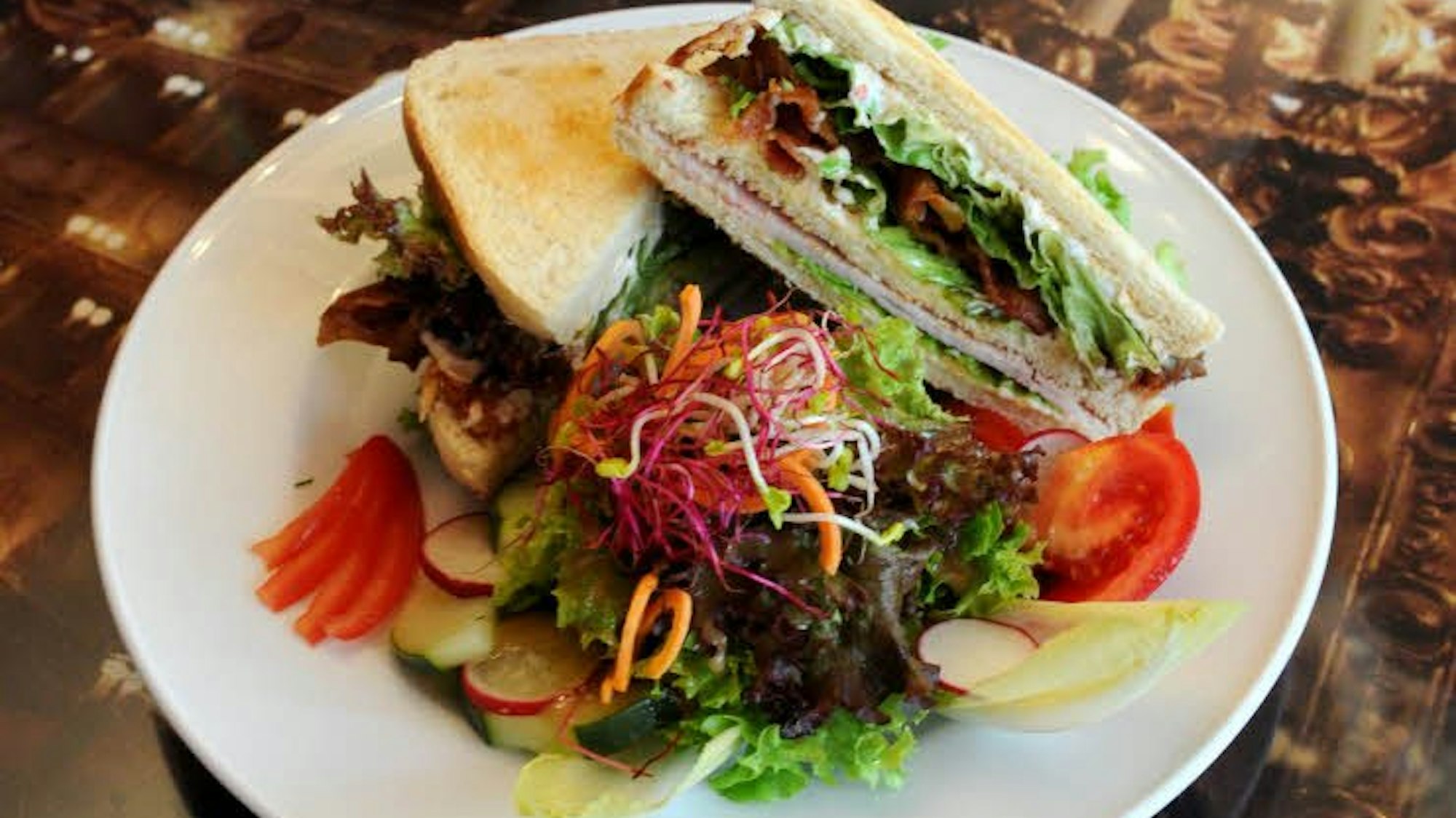 zwei Sandwiches mit Salat auf einem Teller